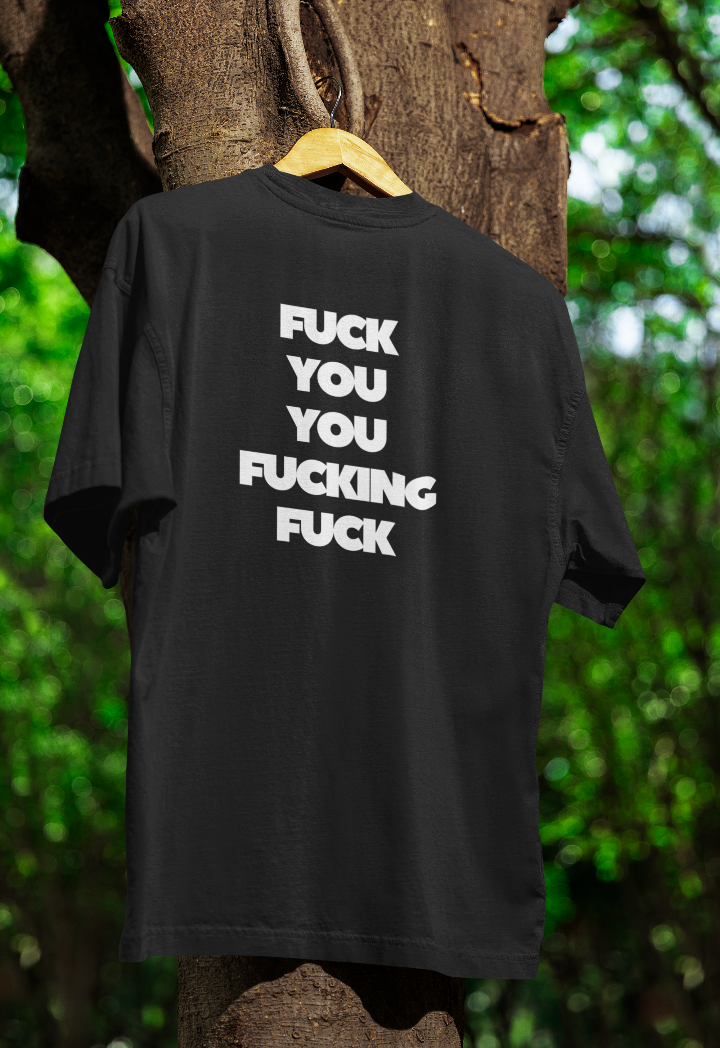 Black shirt on a hanger in a tree with the words fuck you you fucking fuck