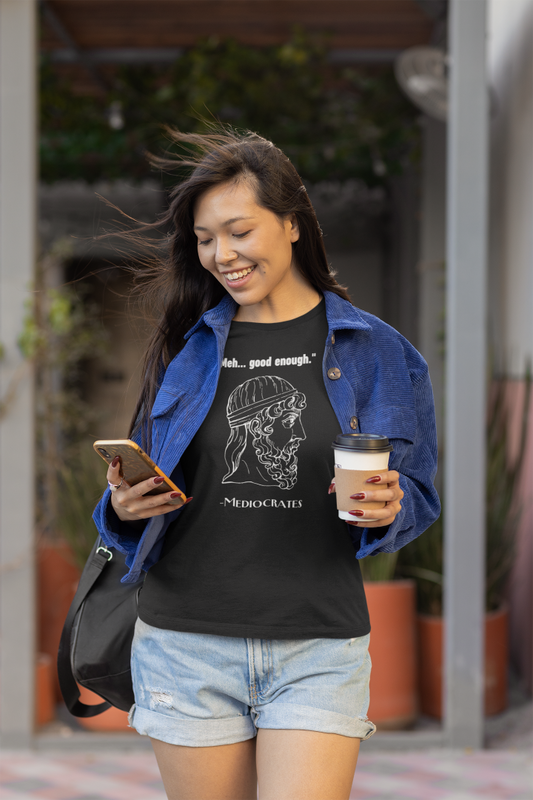 young woman wearing a black tshirt with a graphic of Socrates on it with the words meh... good enough and Mediocrates under the graphic