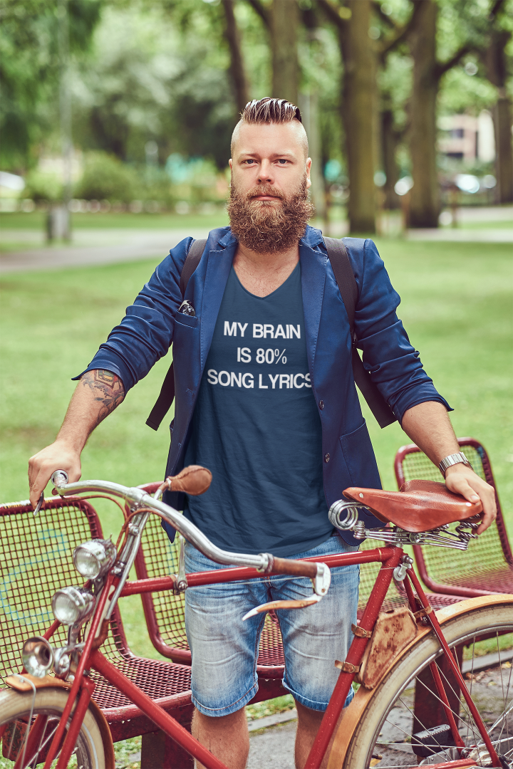 model in a navy blue v neck t shirt that says my brain is 80% song lyrics