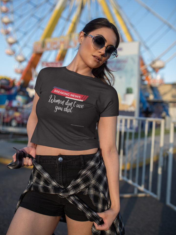 woman in a modified black t shirt that says breaking news women don't owe you shit