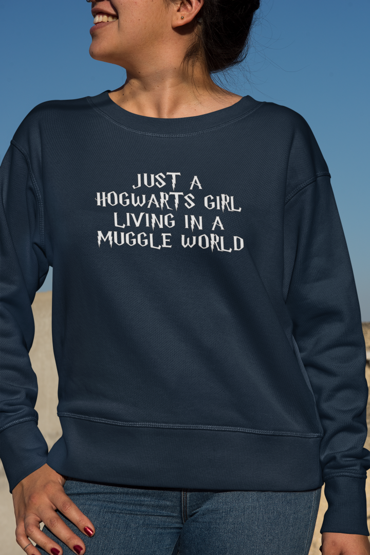 model is wearing a navy blue shirt that says just a Hogwarts girl living in a muggle world