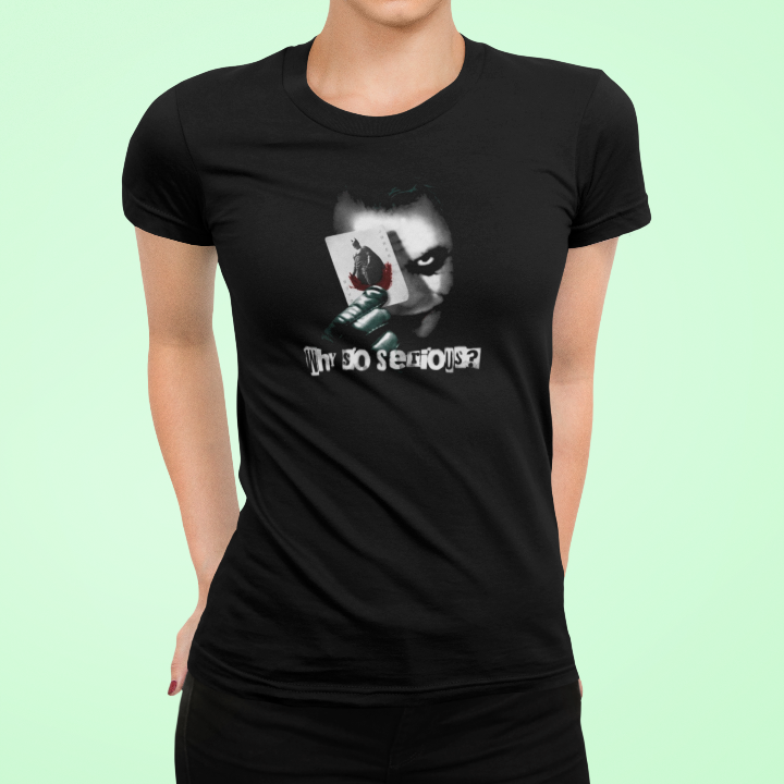 model is wearing a black t shirt that has a graphic of the joker holding a playing card and the words why so serious?