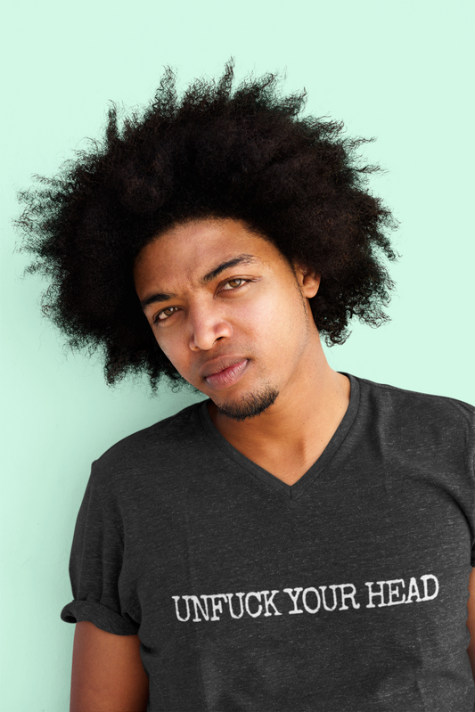 young man with an awesome afro wearing a black v neck t shirt that says unfuck your head